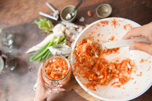Making kimchi: putting the ingredients into a jar