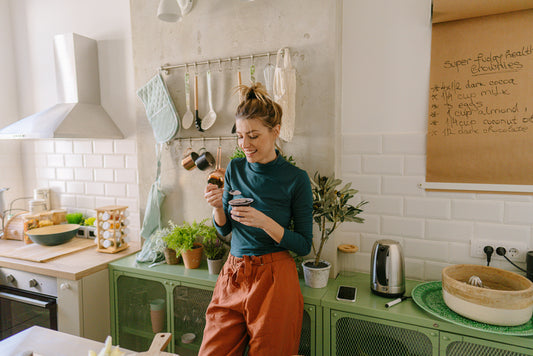 Woman eating yogurt in kitchen