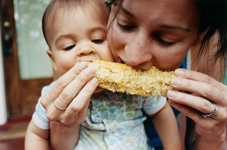 Mother and Baby Eating Corn