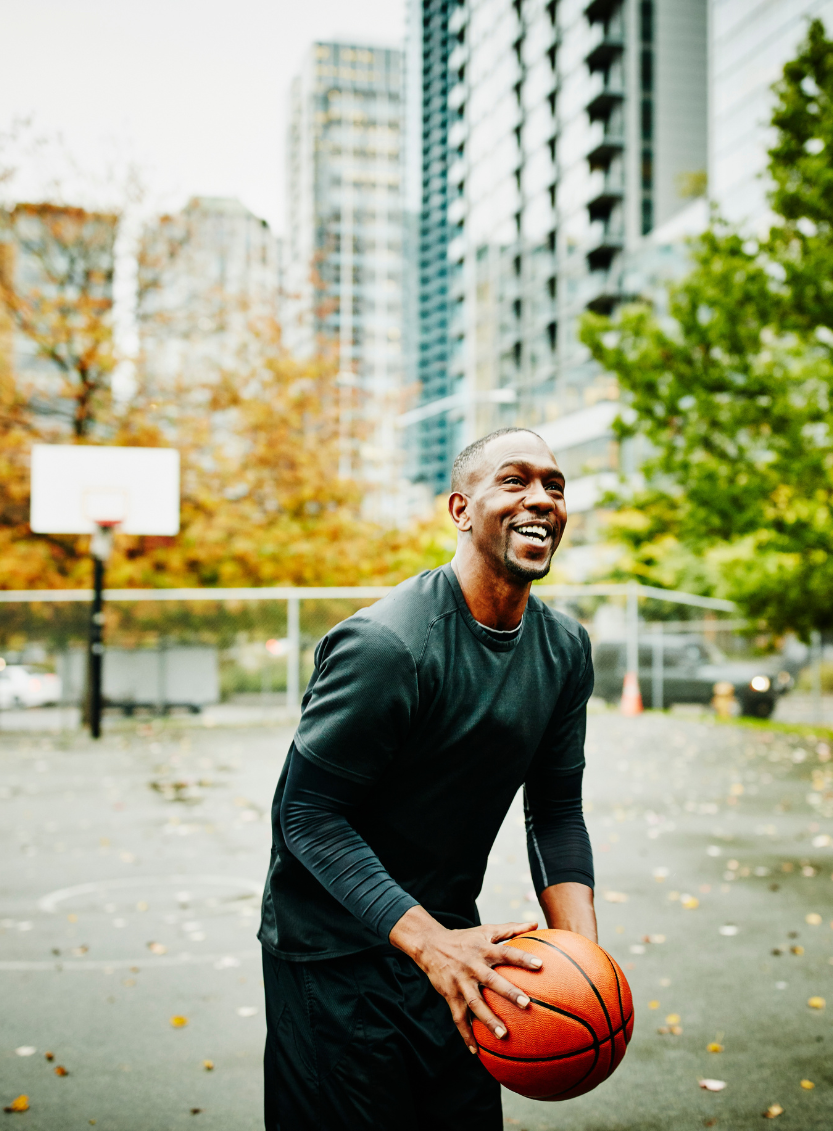 Man playing basketball outside